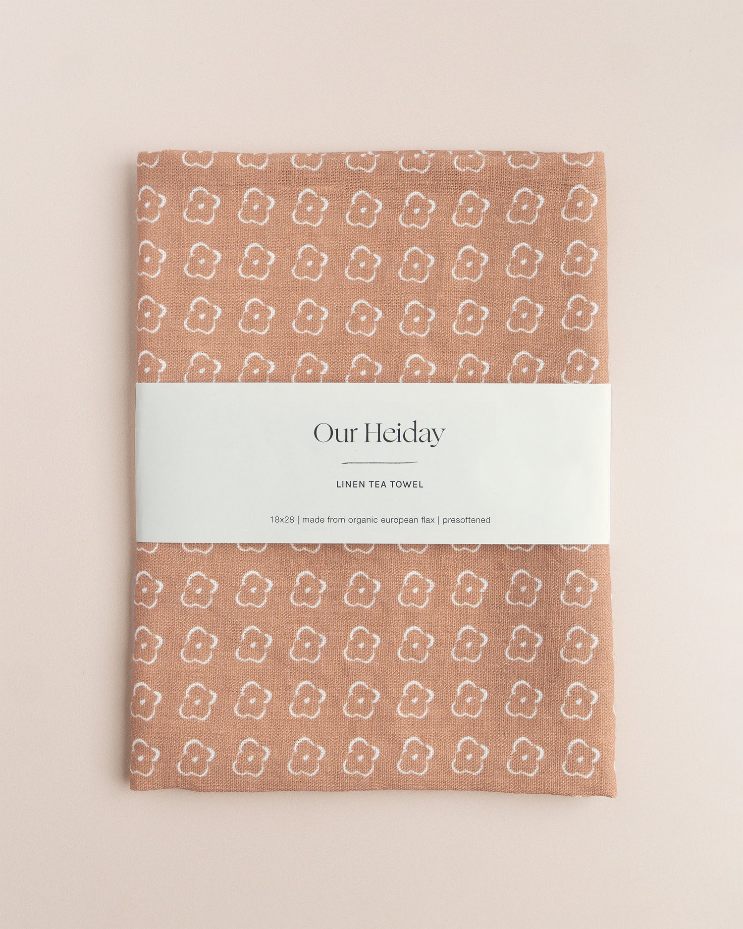Sienna colored tea towel with a floral pattern by our heiday