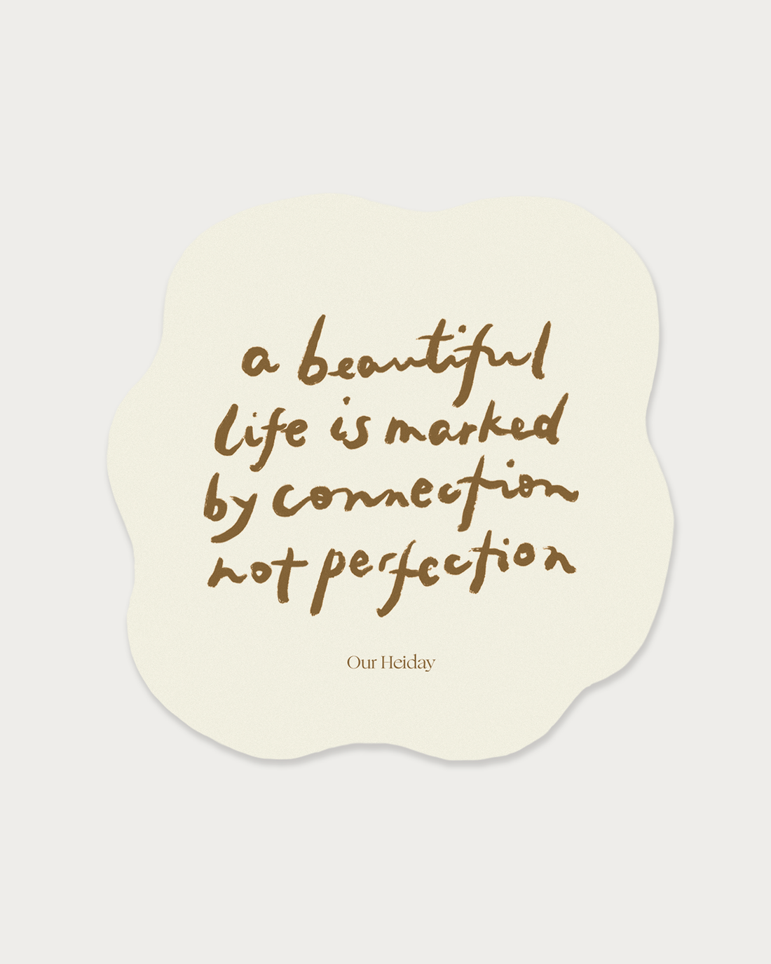 A cream-colored die-cut sticker with an organic wavy shape, featuring the quote &