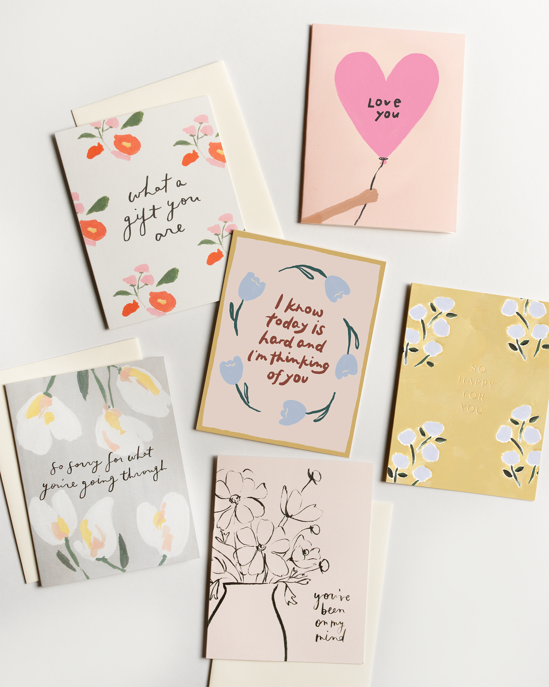 Collection of various greeting cards with different designs and messages on a white background.